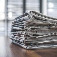 Neatly arranged newspapers on wooden surface with blurred window in background For Social Media Post Size photo