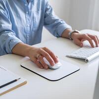 Hands use a white computer mouse on a clean white desk For Social Media Post Size photo
