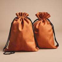 Two orange drawstring bags, one plain, the other revealing contents For Social Media Post Size photo