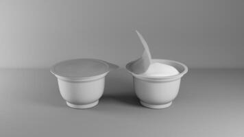 Two yogurt cups with open yogurt on gray background photo