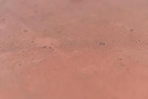 A close up of a red surface with a small hole photo