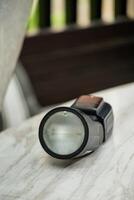 A flashlight on a table photo