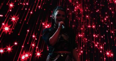 Portrait Of Woman Singer On Stage With Red Led Illumination On Multimedia Display, Gig Of Pop Star video