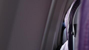 rear view of plane seat inside aeroplane with selective focusing on seat while flying traveling video