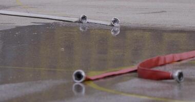 An up-close shot captures a fire hose with a powerful stream of water, highlighting the precision and force of this firefighting tool in action video