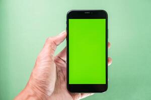 Smart phone with Green Screen in Hand photo