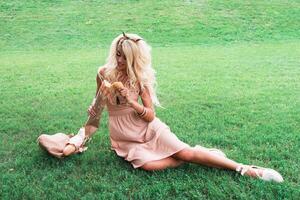 Beauty blonde young woman resting in the park photo