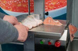 Service for cutting fish on a steak in a fish supermarket photo