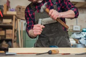 Carpenter working with a chisel photo