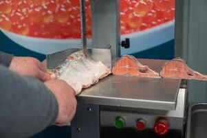 Service for cutting fish on a steak in a fish supermarket photo