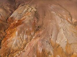 Aerial shot of the textured yellow nad red mountains resembling the surface of Mars photo