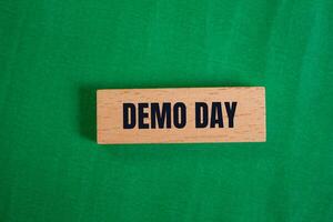 Demo day wooden sign on green background photo