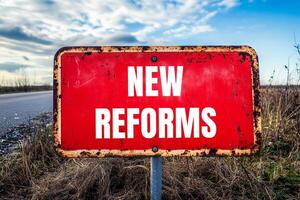 New reforms message written on red metal road sign with nature background. Conceptual new reforms symbol. Copy space. photo