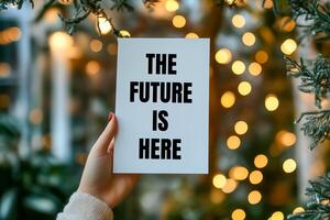 The future is here message written on white with bokeh lights background. Conceptual the future is here symbol. Copy space. photo