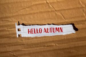 Hello autumn text on torn paper photo