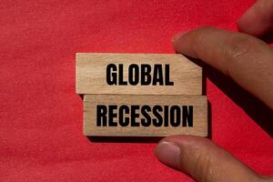 Global recession message written on wooden blocks with red background. Conceptual global recession symbol. Copy space. photo