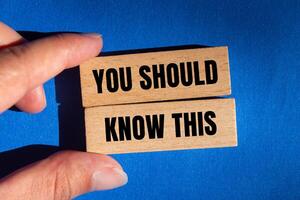 You should know this message written on wooden blocks with blue background. Conceptual you should know this symbol. Copy space. photo