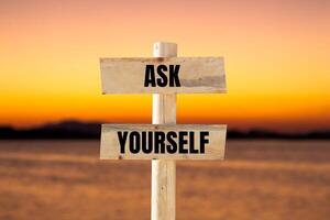 Ask yourself message written on wooden sign with blurry lake background. Conceptual ask yourself symbol. Copy space. photo