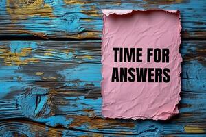 Time for answers text on torn piece of paper on wooden background photo