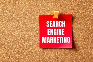 Search engine marketing message written on red paper with brown background. Conceptual search engine marketing symbol. Copy space. photo