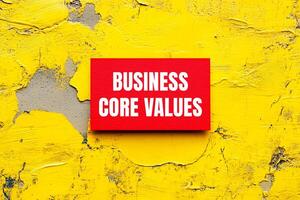 A red sign on a yellow wall that says business core values photo