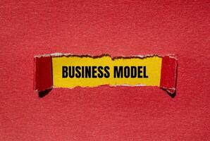 Business model message written on ripped torn red paper with yellow background. Conceptual business model symbol. Copy space. photo