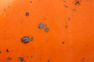 A close up of a orange object with a few spots photo