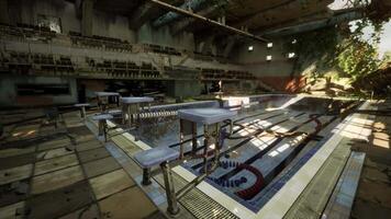 An eerie abandoned swimming pool in an old building, devoid of water and life video