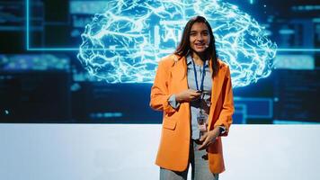 Lively speaker talks at AI event gathering tech startups managers, investors and academics. Expert hosts sessions geared towards helping IT business leaders tap into artificial intelligence, camera A photo