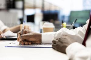 Recruiter signing contract after finding best talent to fill open company position. Close up of human resources employer hired to assess skills of candidate, filling paperwork photo
