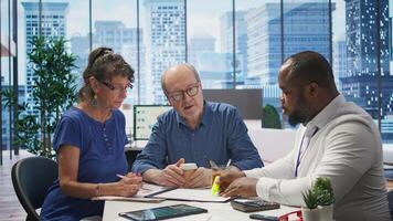 Mature couple receiving professional advice on retirement planning, exploring a new investment strategy and pension options to increase savings. Life insurance income package. Camera B. photo