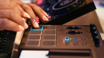 Audio engineer producing new music on mixing console in home studio, working with sound effects and pre amp knobs. Skilled producer creating songs and adjusting volume levels. Close up. Camera A. photo