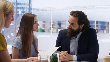 Financial advisor assessing clients economic goals to provide personalized planning guide during office meeting. Agent optimizing investment returns for mother and daughter requesting help, camera B photo