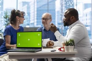 Elderly people consulting with financial expert during meeting in modern office, exploring various retirement and pension plans. Senior couple discuss with advisor about the future. photo