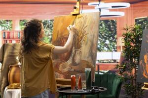 Painter being inspired of natural rustic decorations for a masterpiece painting, using modern paintbrushes in art studio. Working with motivation and creativity for fine art creative process. photo