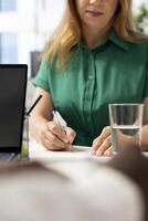 Person writing with pen on contract papers after qualifications aligned with company expectations. Close up of applicant filling application form files after making recruiter happy with resume photo