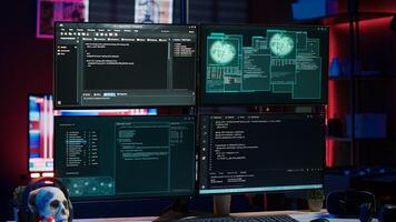 Lines of code running on computer monitors in empty room used by cybercriminal stealing sensitive information. Dangerous scripts on PC used for threatening network systems, panning shot photo