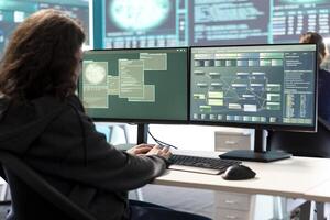 Governmental hacker expert working on securing digital information, analyzes intelligence on big screen. Specialist works to prevent cyber threats with advanced technology, cyberterrorism. photo