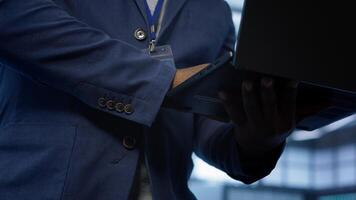 Admin in data center runs system diagnostic tests and error checking utilities on laptop to fix problems. Close up shot of worker looking for network issues affecting rigs performance, camera A photo