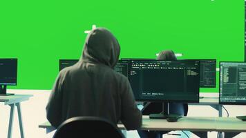 Cyber security experts working with mockup layout on a big screen, using encryption and IT security in a governmental agency. Focusing on cyber operations to hack rival states systems. Camera A. photo