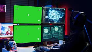 Hacker listening music while using isolated screen PC and AI to steal data. Scammer wearing headphones using artificial intelligence and mockup computer to compromise digital devices, camera A photo