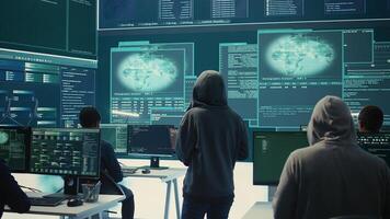 Disappointed team of governmental hackers failing to access database and servers in high tech office, work with big screen to steal passwords for hybrid warfare. Frustrated experts. Camera B. photo