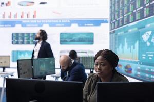 General director employing big data to help in solving tasks in control room, operating on huge screen to create a performance metrics analysis. Manager ensuring organizational efficiency. photo