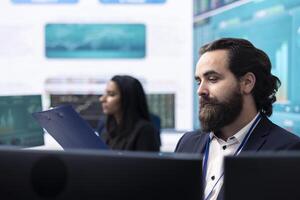 Professional finance advisor studying annual productivity reports, learning the obstacles and performance metrics on pc. Business specialist examines big data infographics for firm success. photo