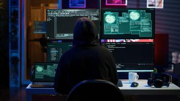 Hacker arriving in hidden underground shelter with laptop, prepared to launch malware attack on websites. Scammer in apartment starting work on dangerous script that can breach security, camera A photo