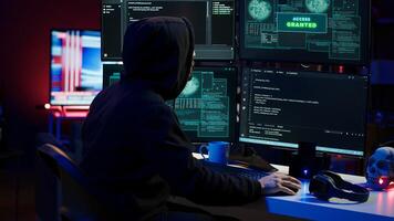 Hacker happy after successfully penetrating firewalls using malware, seeing access granted notification. Rogue programmer successfully gaining access to victim data, camera A photo