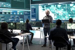 Hackers team engaging in governmental espionage and using phishing techniques for illegal access to data, working on national security breach. Spyware agency gains access on a big screen. photo