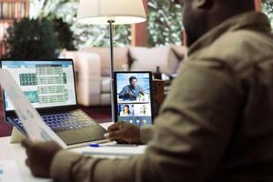 Business owner presenting the financial data reports to the investors members of the board, discussing on online videocall about expansion plans and new funding. Accounting analysis. photo