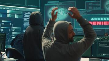 Disappointed team of governmental hackers failing to access database and servers in high tech office, work with big screen to steal passwords for hybrid warfare. Frustrated experts. Camera A. photo