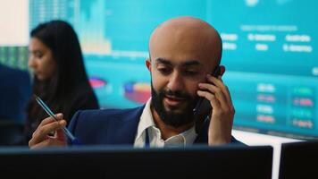 Business analyst does a presentation with project updates on phone call, discussing with CEO to ensure organizational success. Employee allocating resources according to the market needs. Camera A. photo
